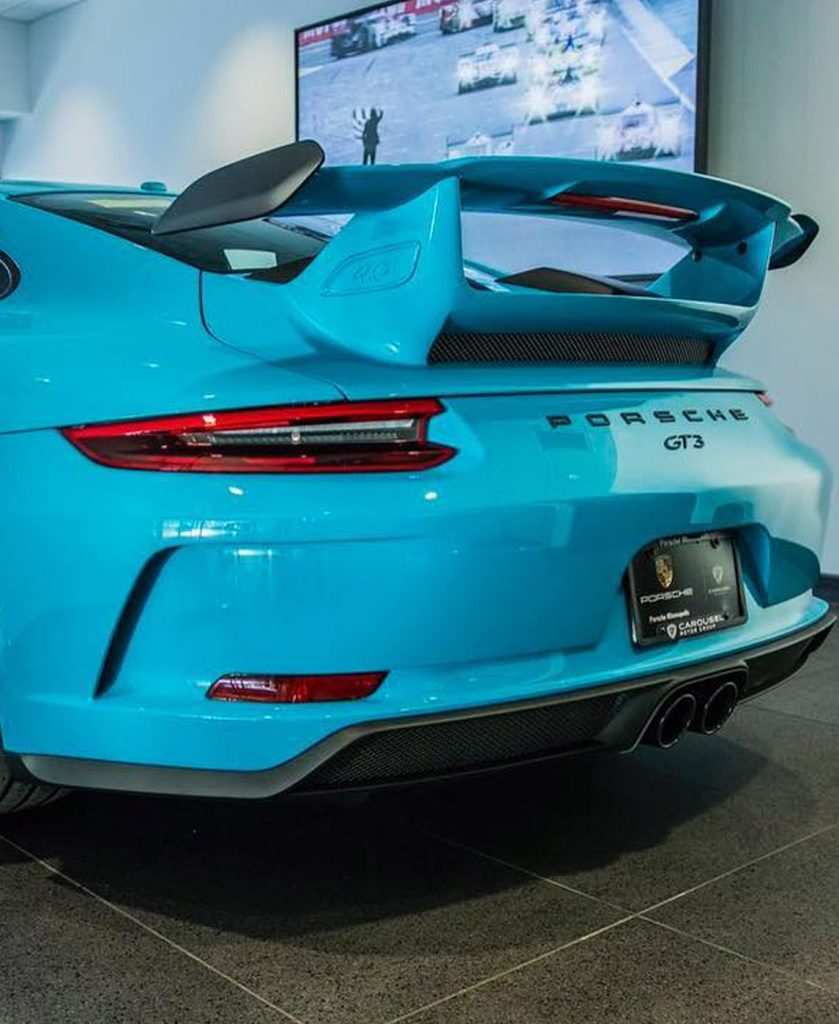bright blue car with large body kit spoiler modification