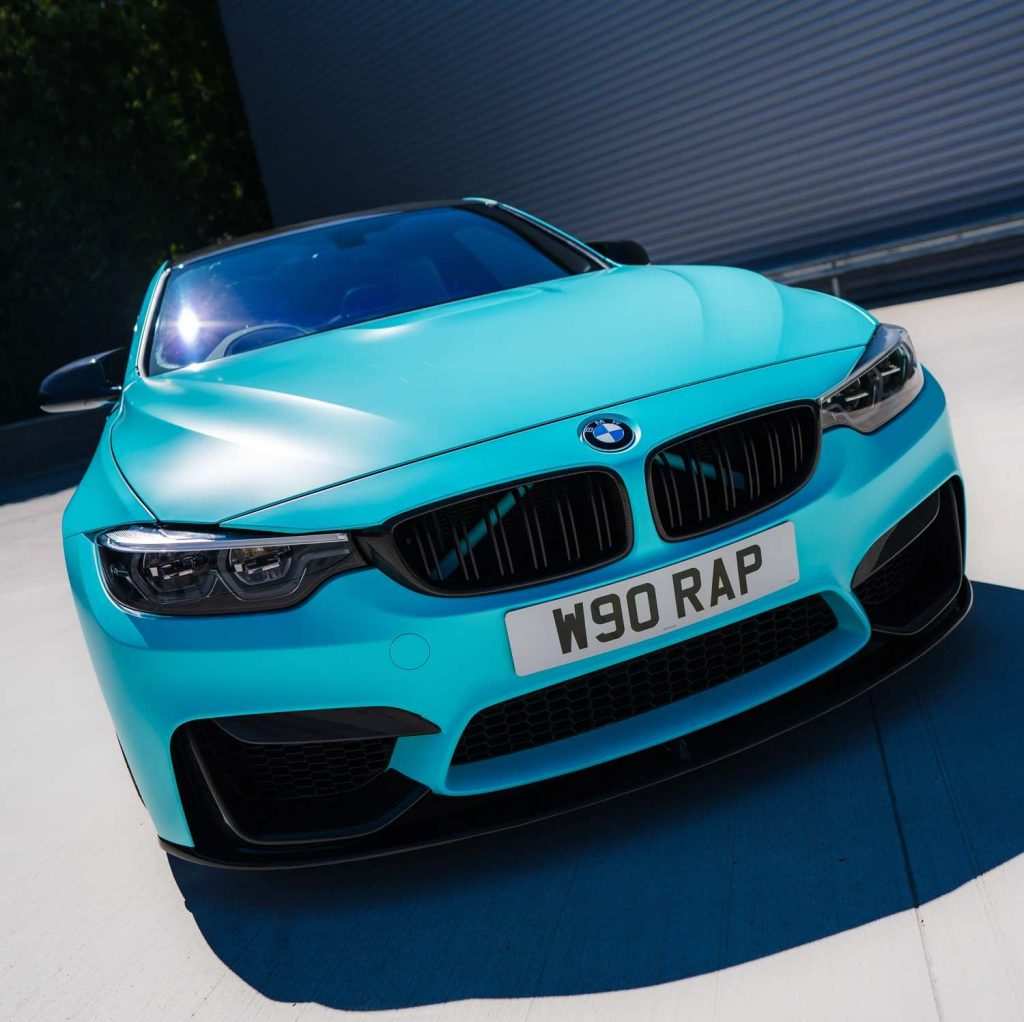 Blue BMW M4 outside garage