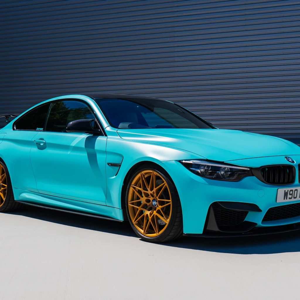 BMW M4 blue outside garage