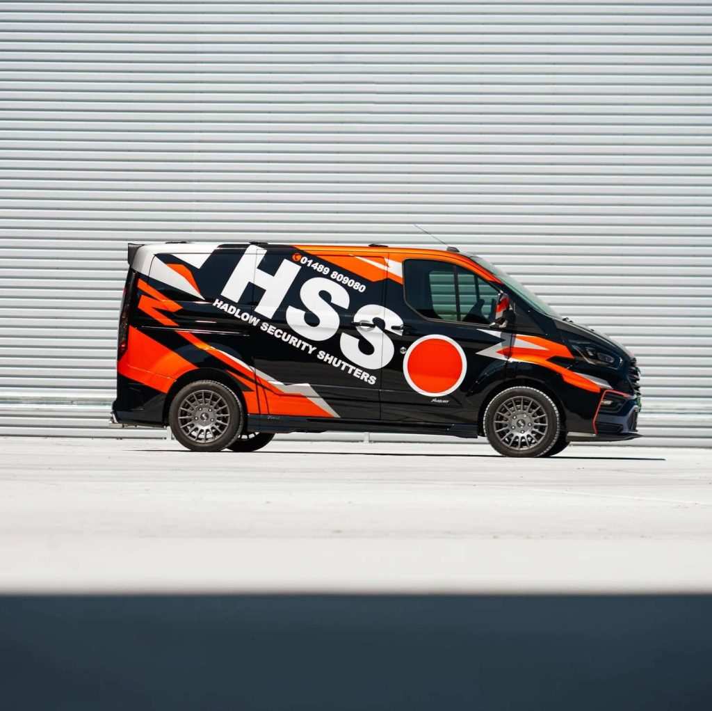 Customised ford transit parked in front of garage