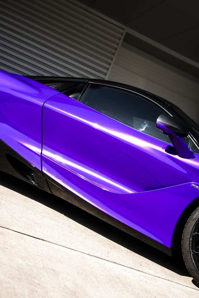 Side profile of McLaren in purple wrap