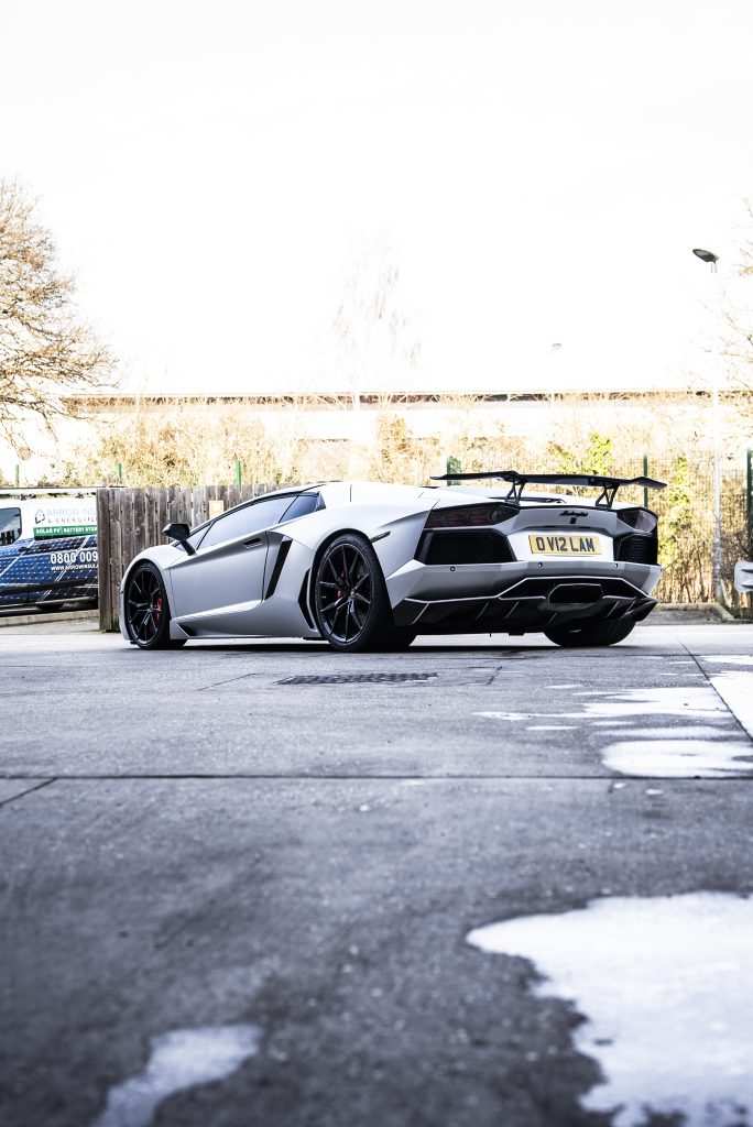 Supercar wrapped in satin white aluminium vinyl
