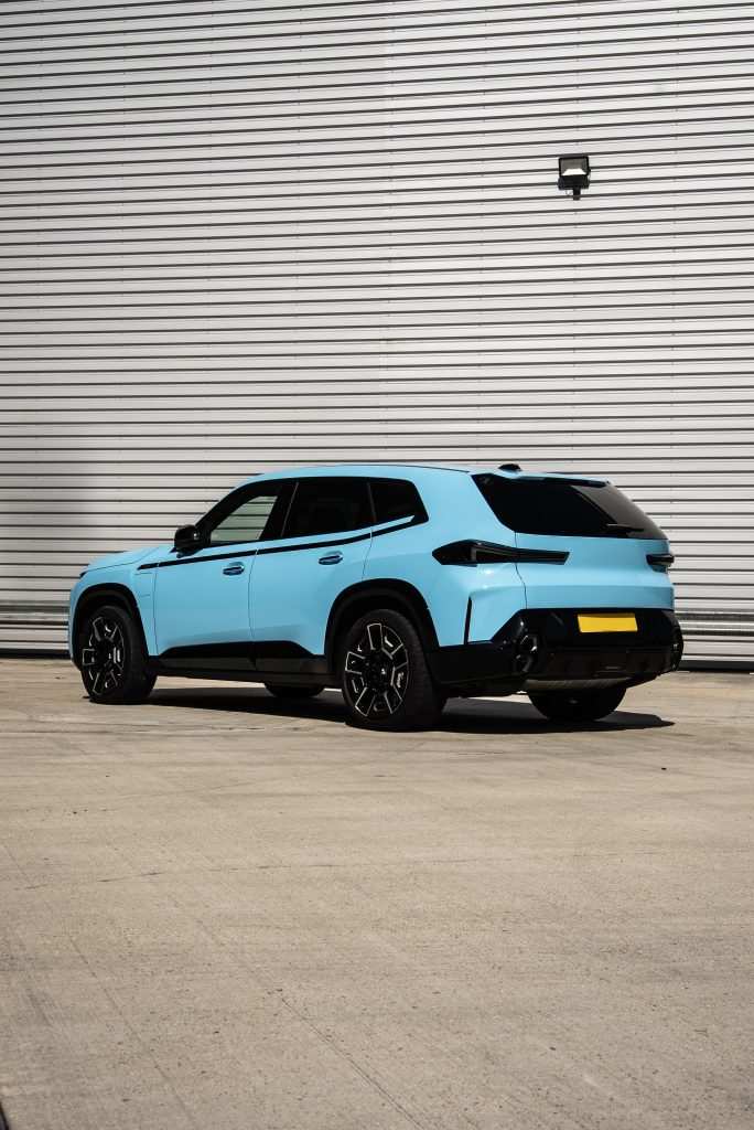 Side profile of BMW XM in gloss blue