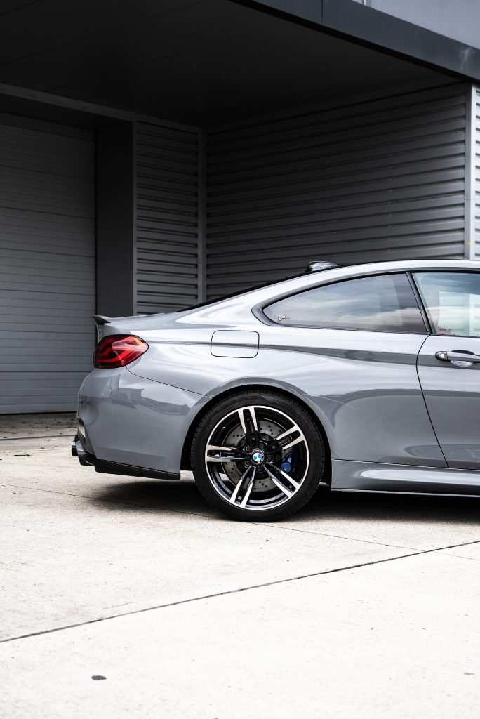 Side profile of BMW M4 in gloss grey